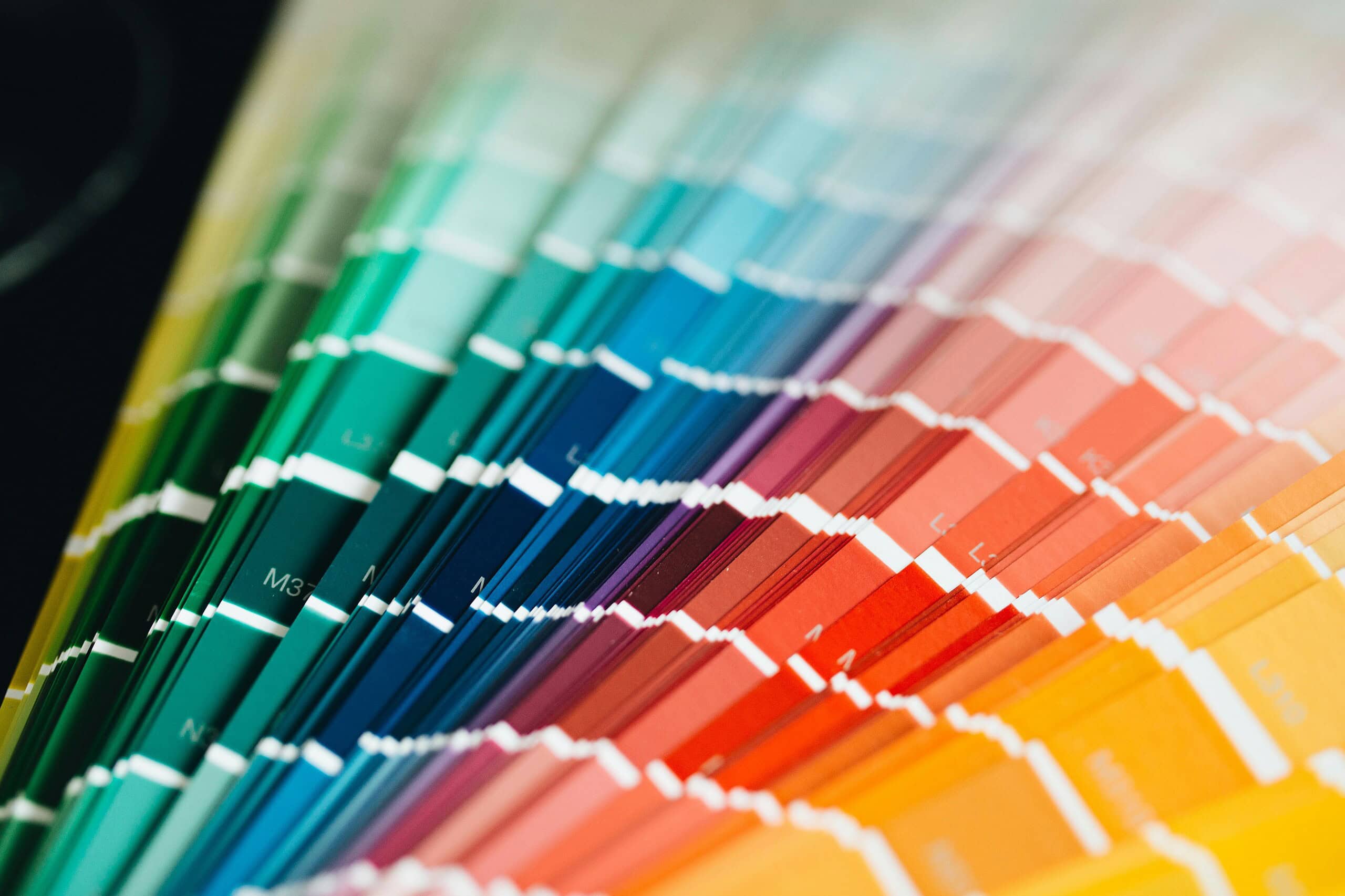 A close-up view of a professional color swatch book, showcasing the precision of Brand Style Guide Services in New York.